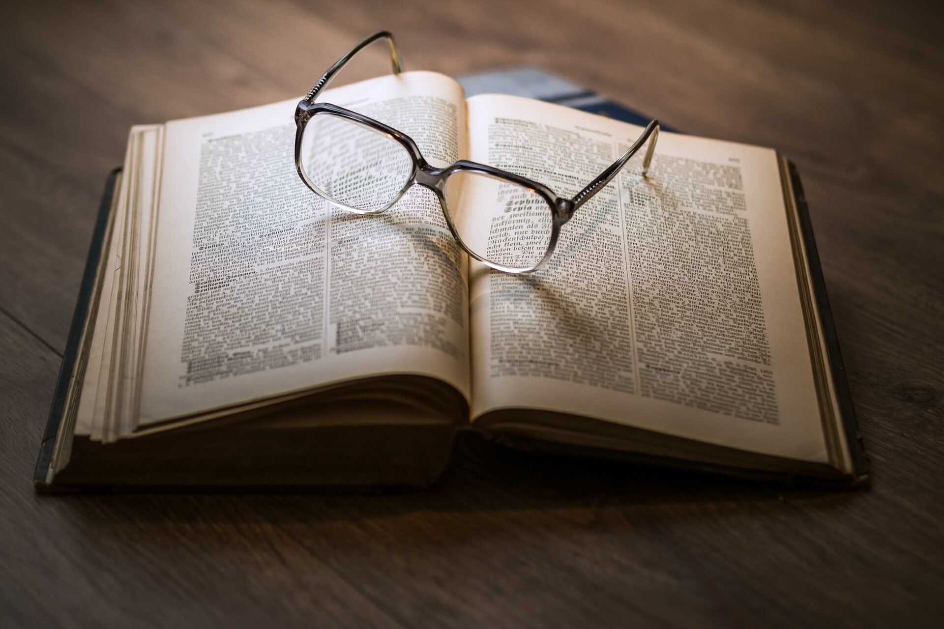 framed eyeglasses on top open book