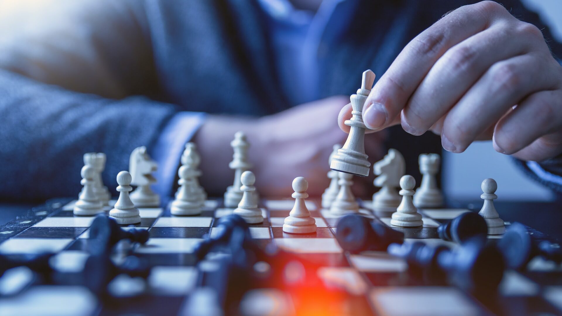 depth of field photography of man playing chess