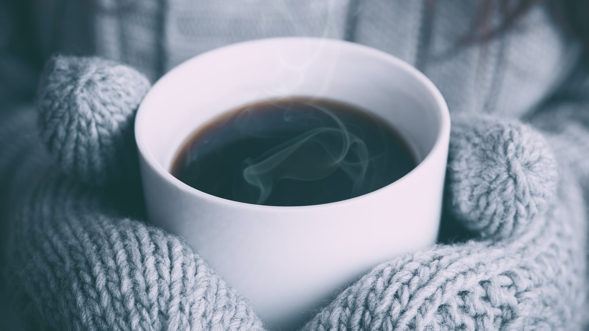 person holding white ceramic mug