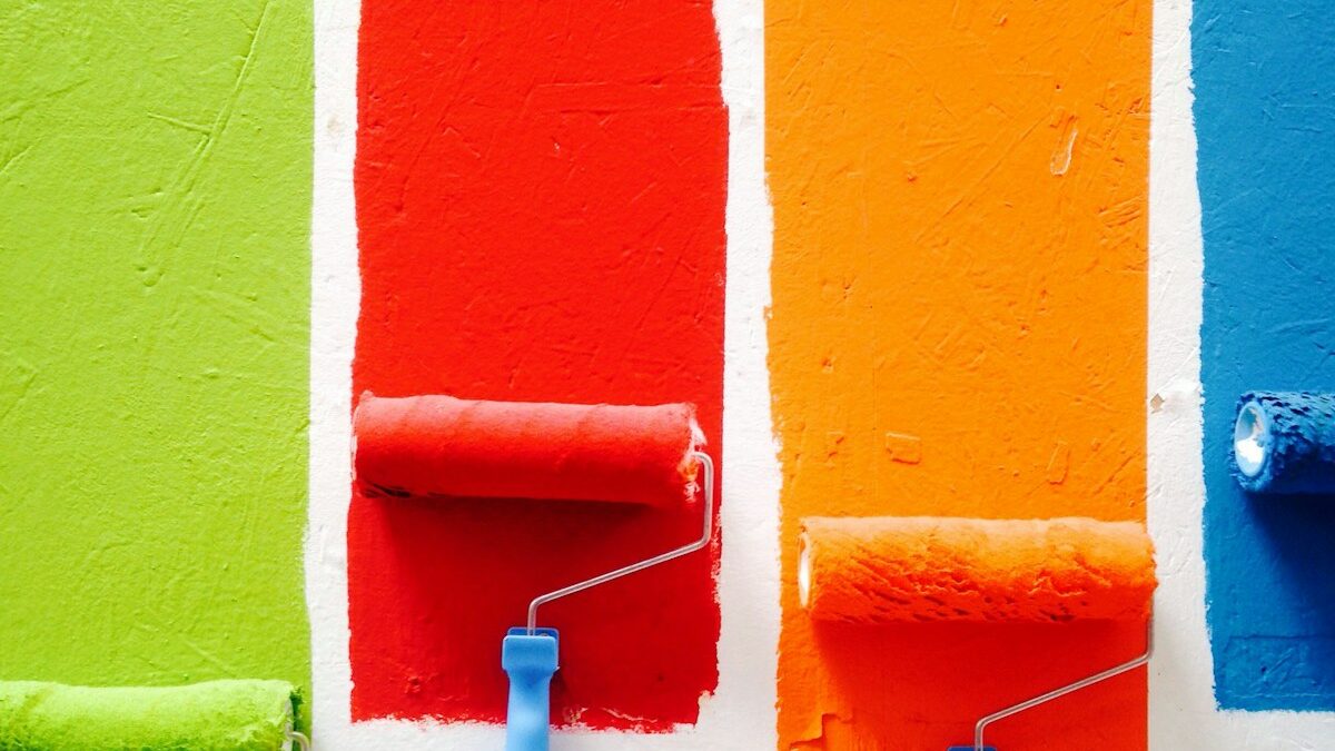four orange, green, blue, and red paint rollers