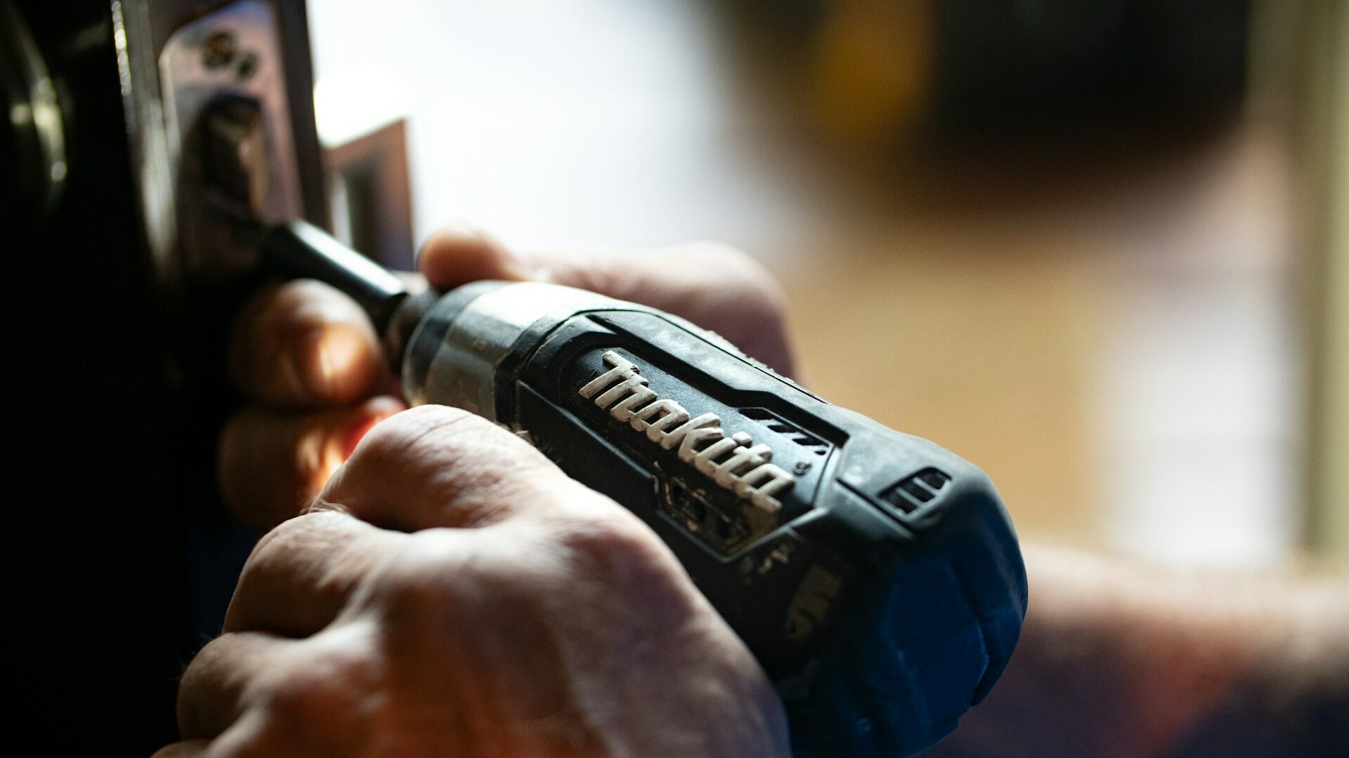 selective focus photography blue and black Makita power drill